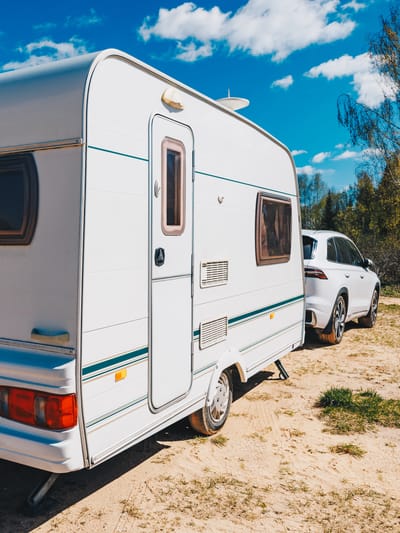 white-trailer-caravan-car-is-parked-on-the-side-of-road